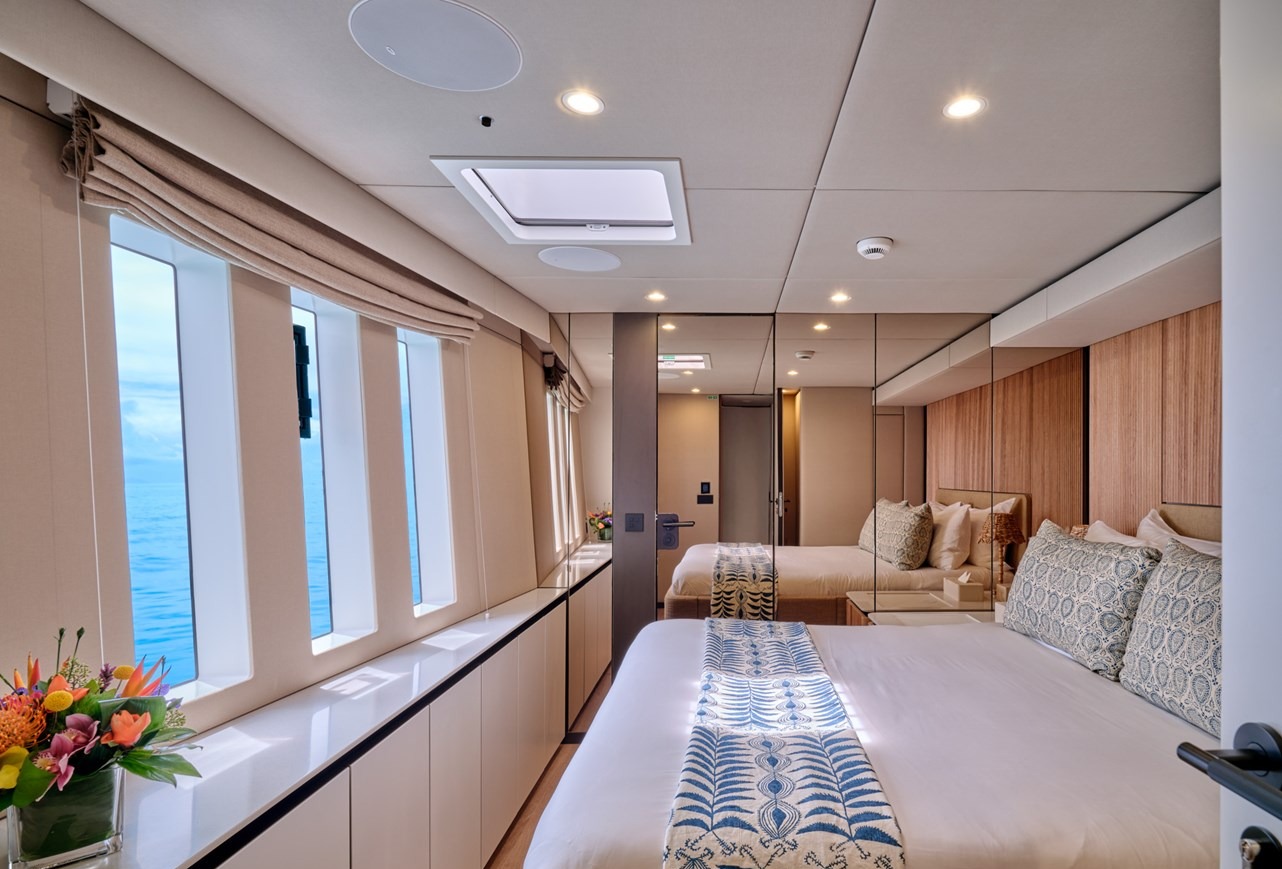 Guest cabin of the Sunreef 80 with sea views through panoramic windows