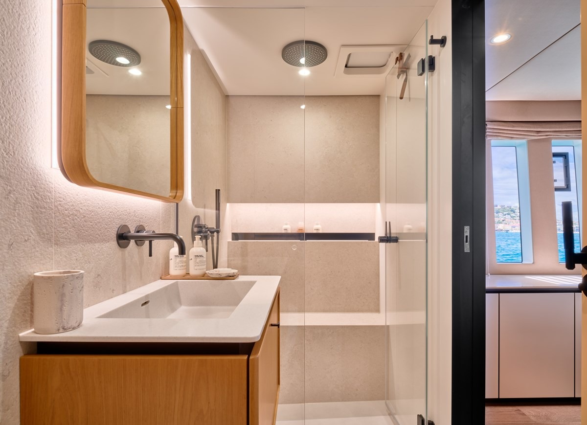 En-suite bathroom of the Sunreef 80 with rain shower and stone finishes